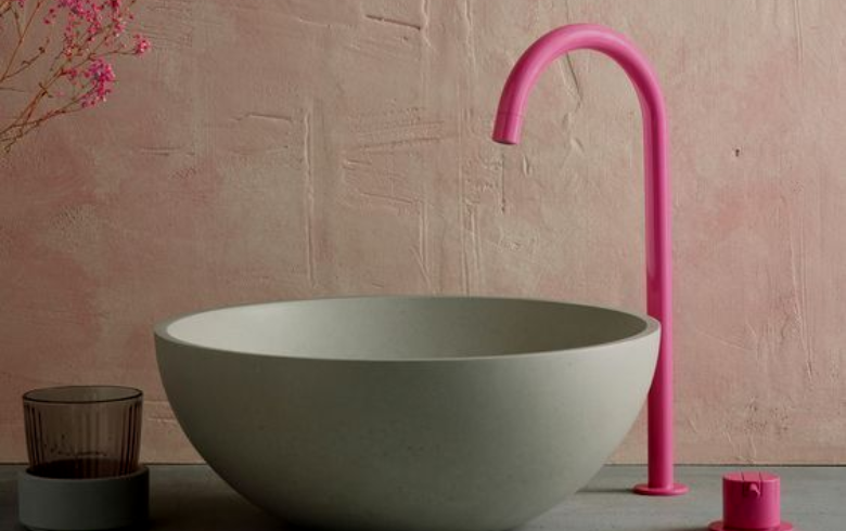 Small home improvements like this pink faucet in the bathroom add whimsy and flair
