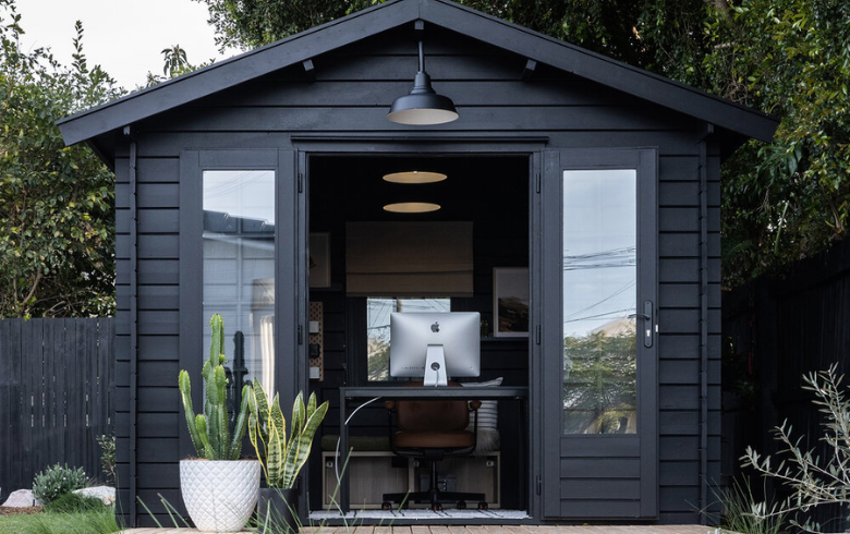 home addition with office black shed in backyard