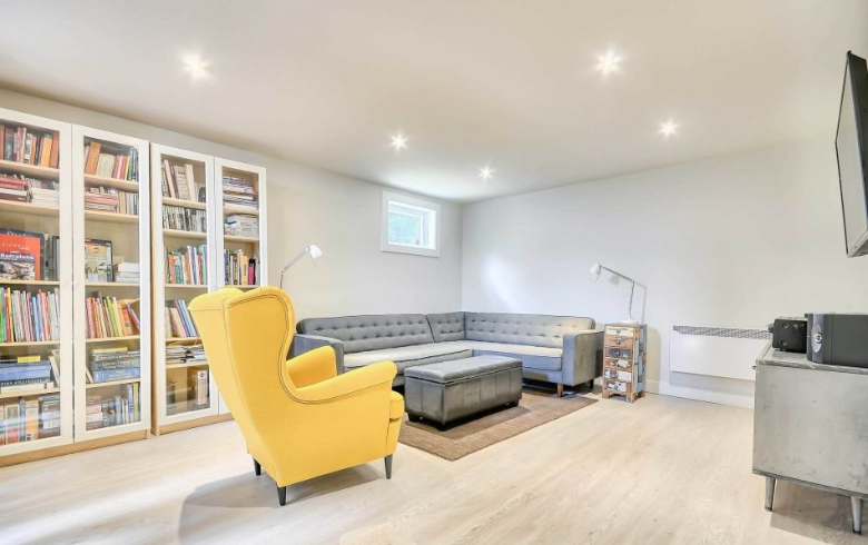 living room in basement with l shape sofa and library