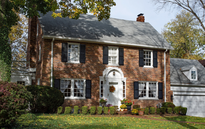 colonial home with brickwall façade