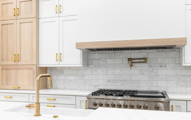 two-tone white and blond wood kitchen new gold hardware