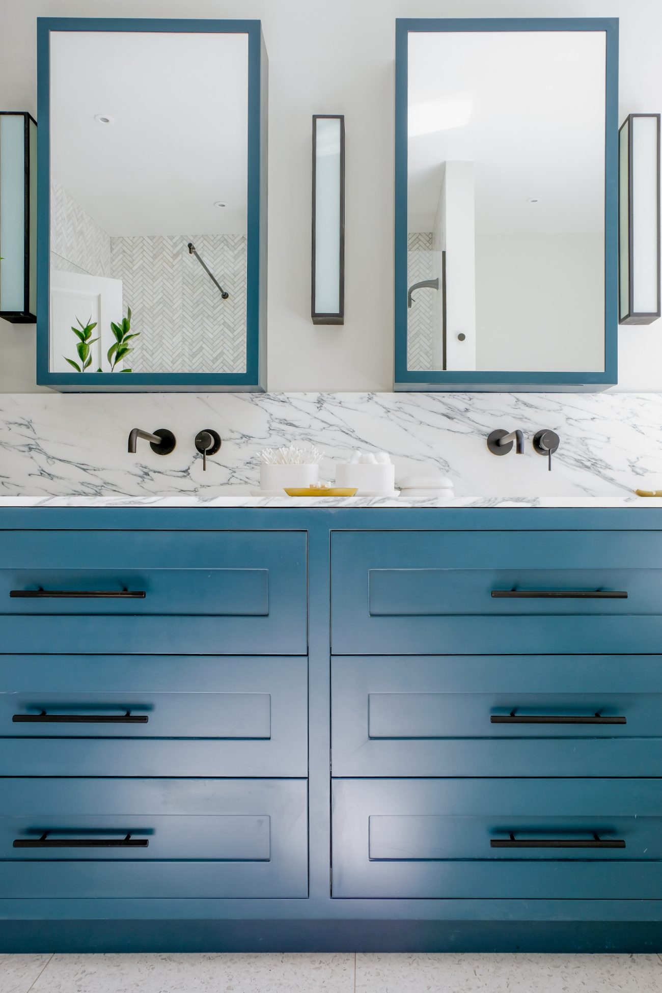 Extended marble countertop and backsplash with blue vanity