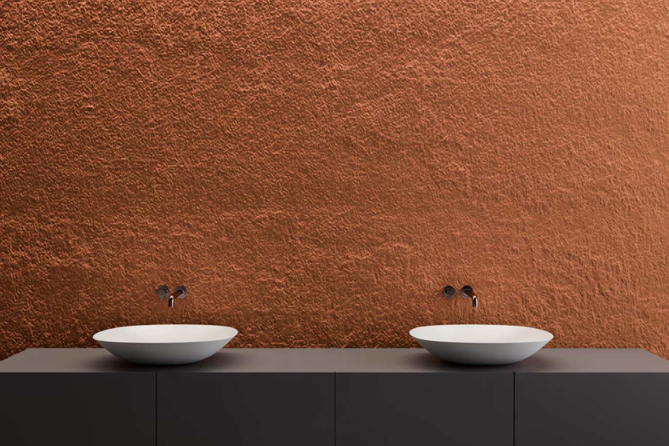 Modern bathroom with orange terracotta wall, two white sinks and wall-mounted faucets