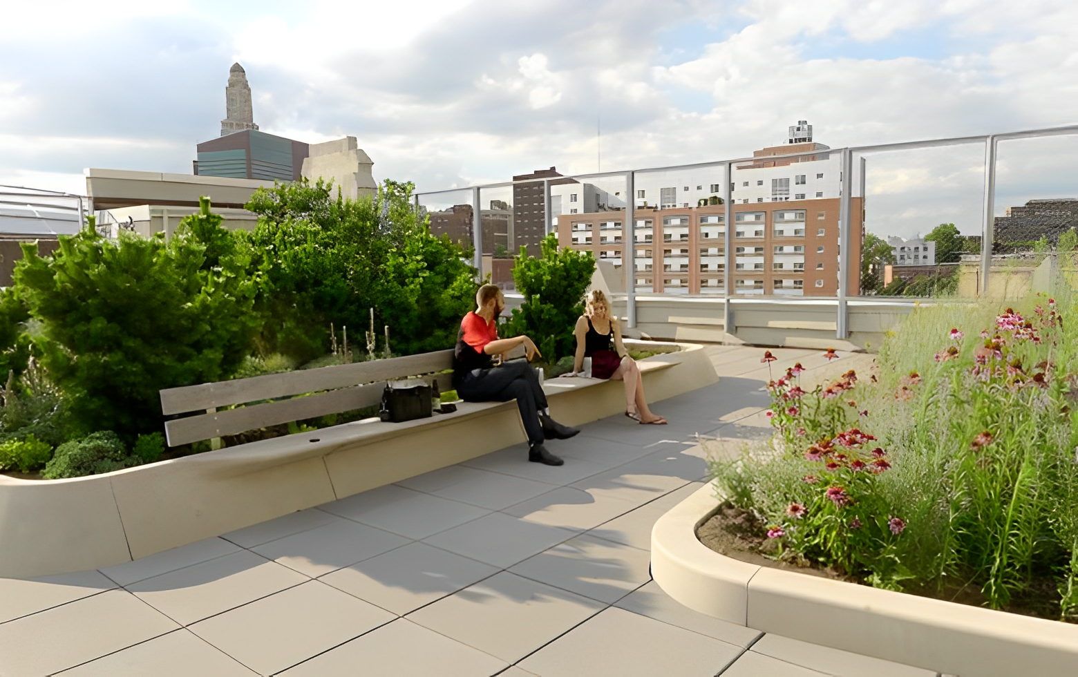 people enjoying green roof with flowers, plants, and benches