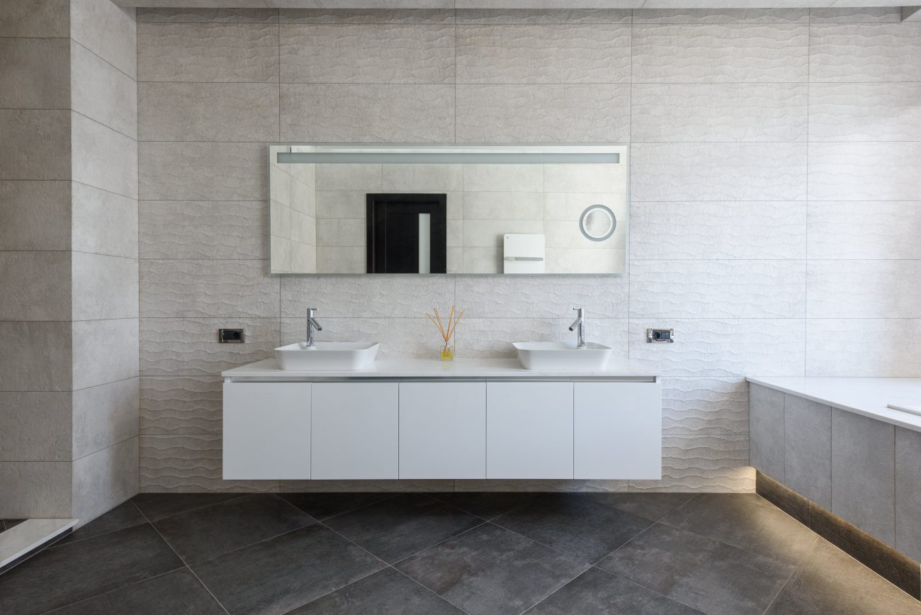 Large rectangular mirror above a double vanity