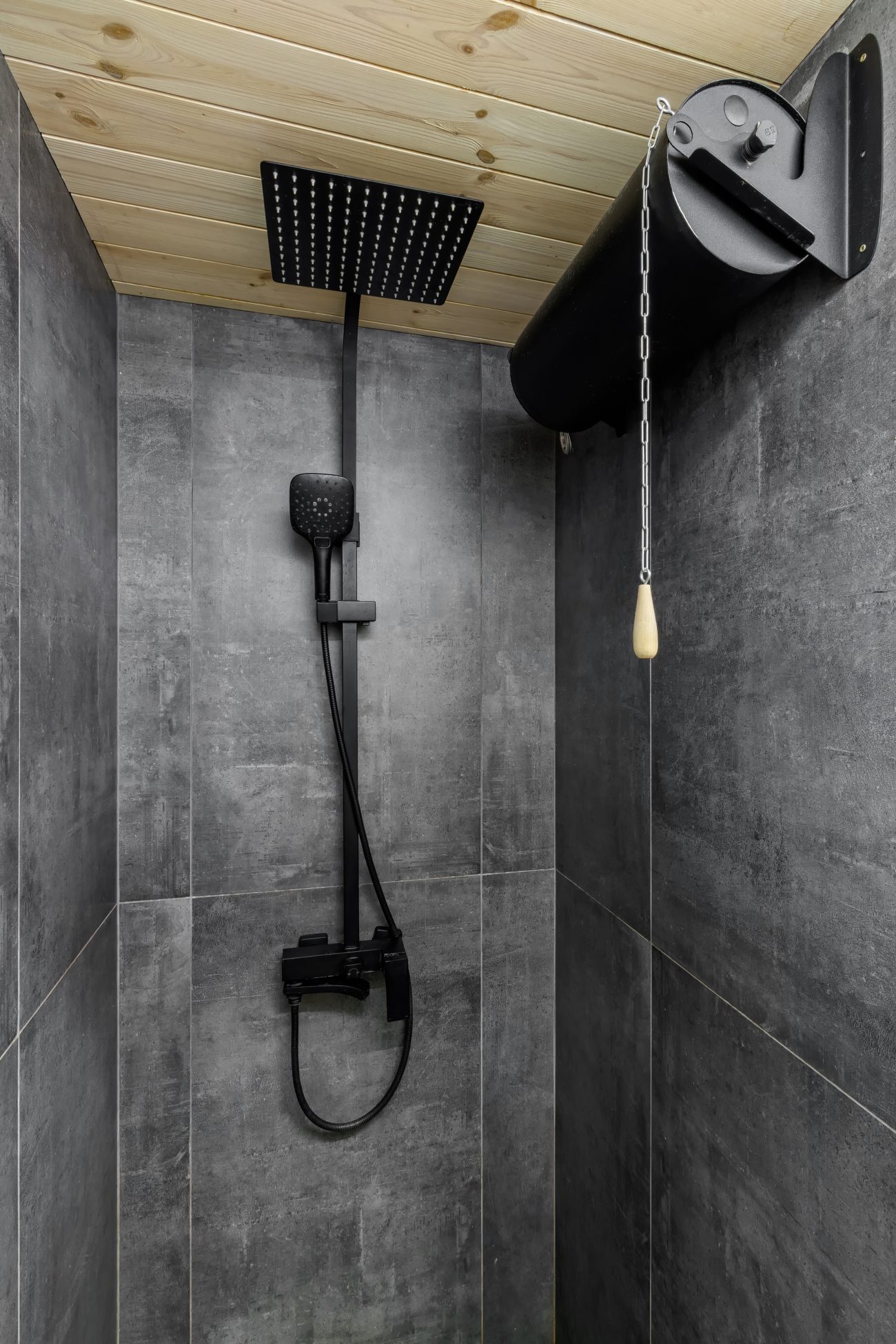 Rain shower behind a wall with black square shower head