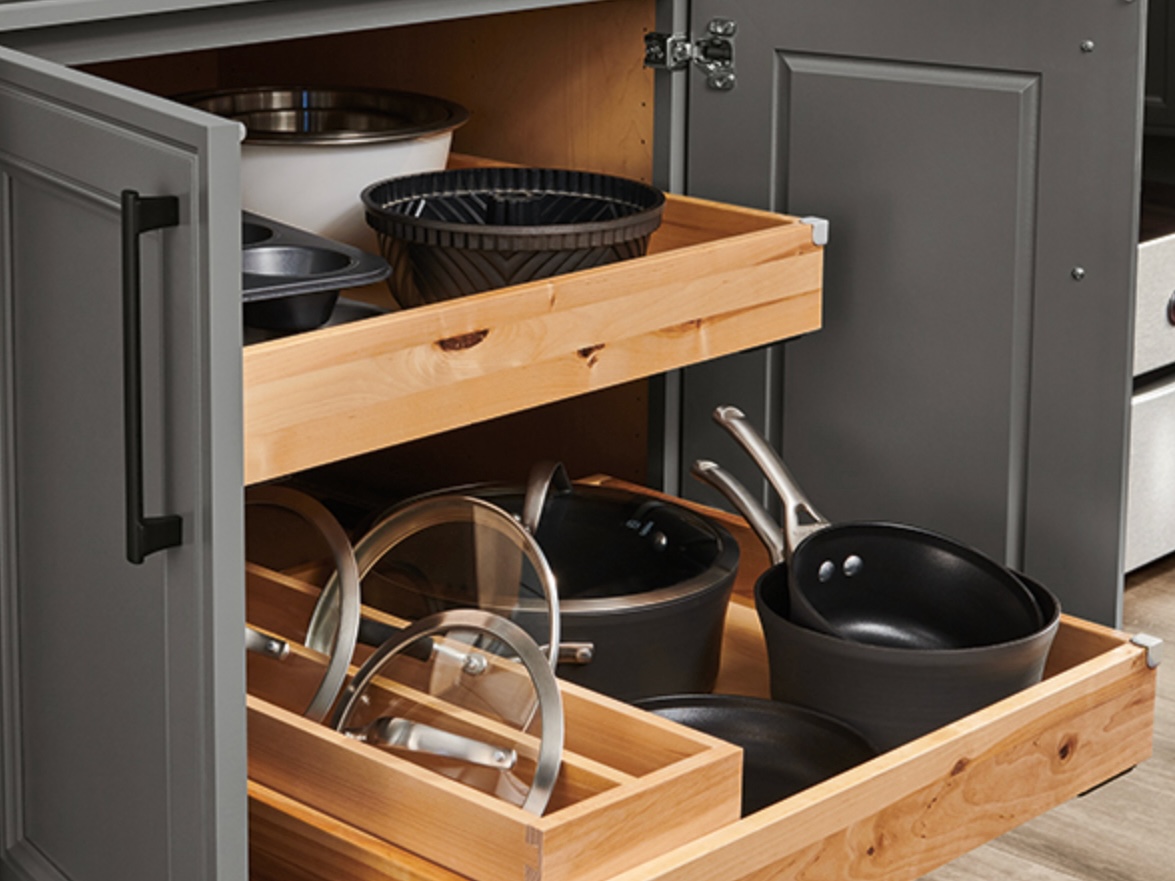 Grey kitchen cabinet with wood drawers and cookware sets